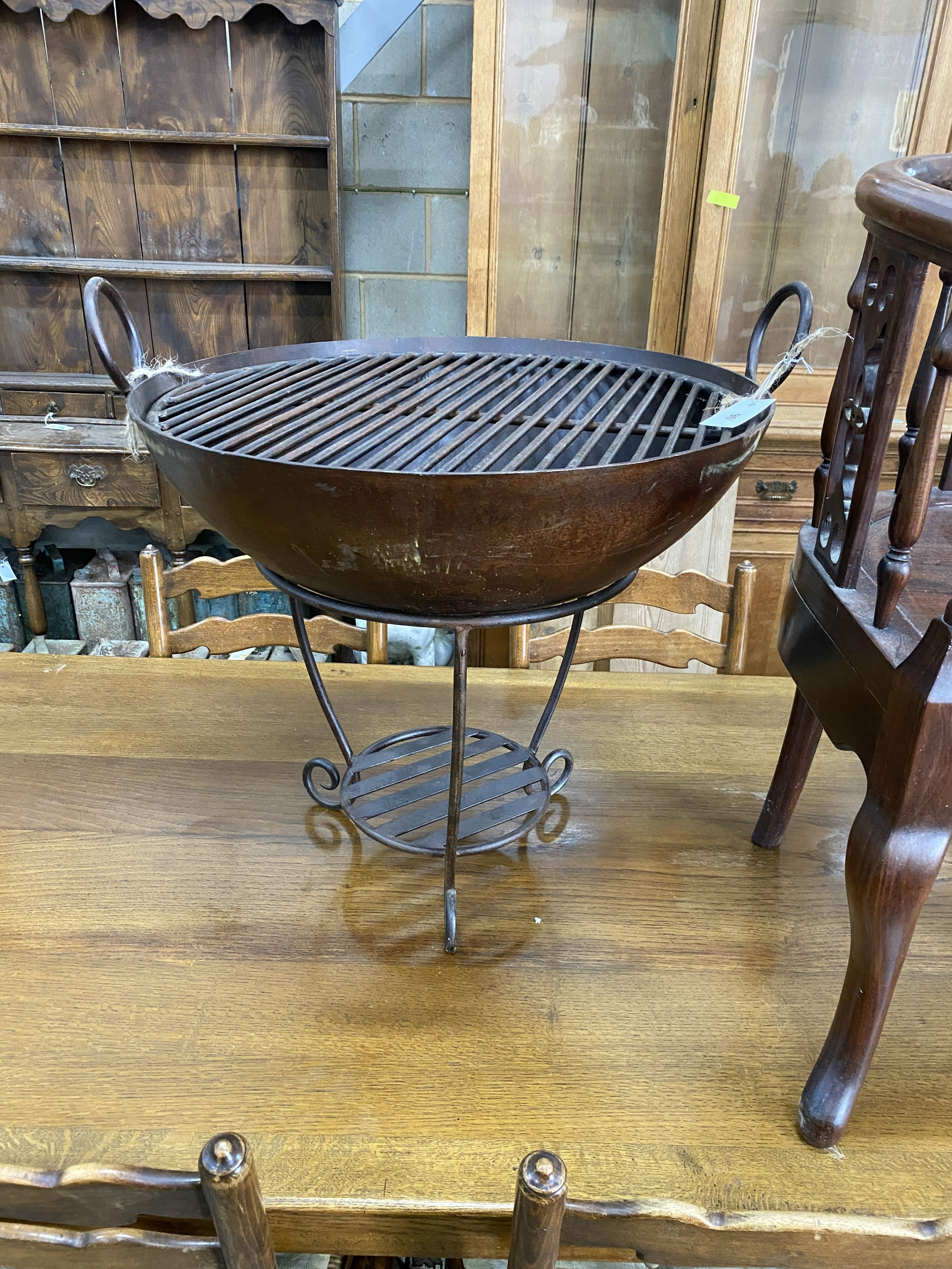 A wrought iron fire pit, diameter 61cm, height 57cm